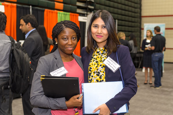 Finance graduate student Aderonke Adeleye and business analytics graduate student Nidarshana Dhakal at the UT Dallas Career Expo