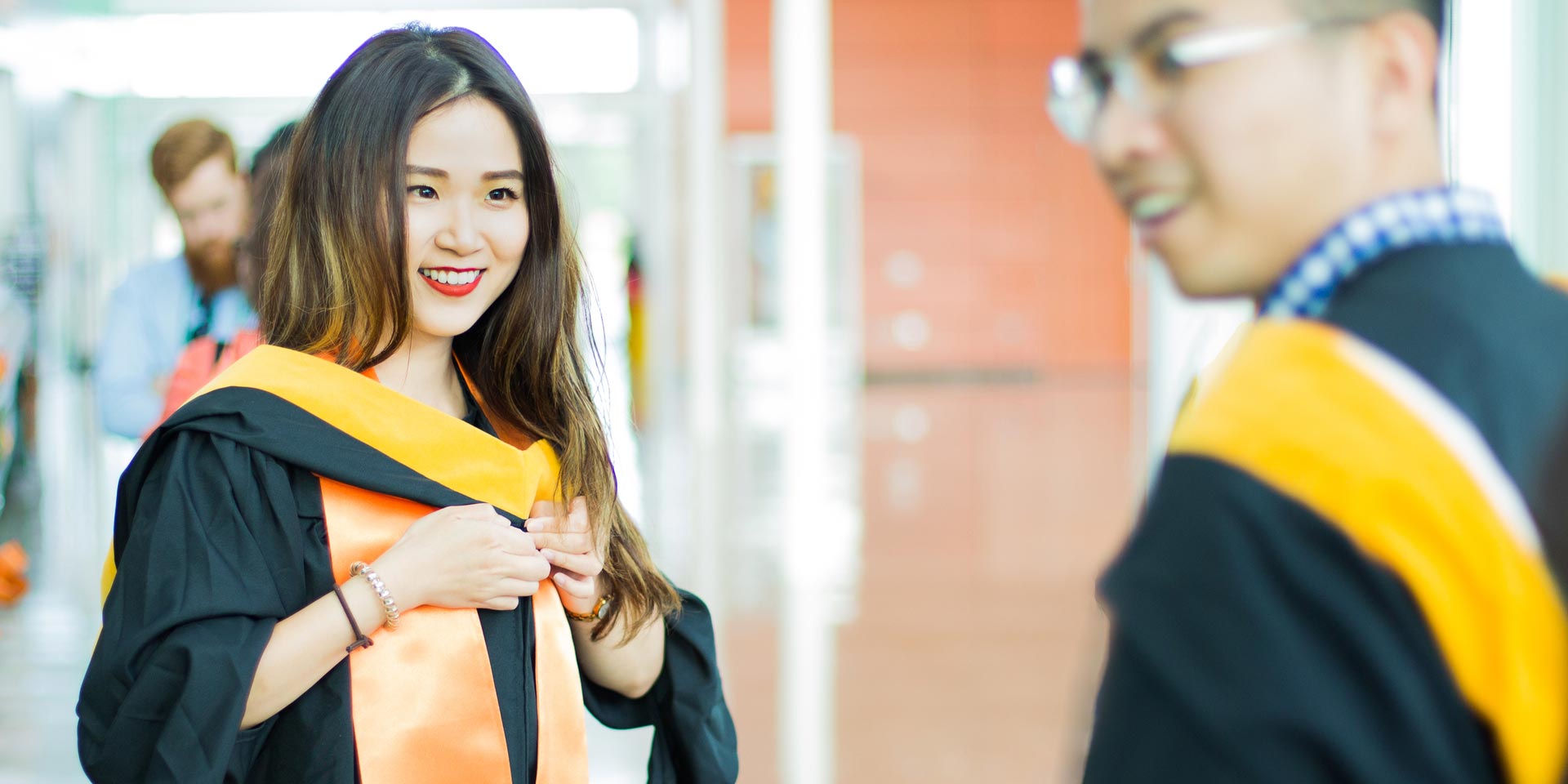 Nai-Jui Kuo prepares her robes and stoles before she graduates with master’s degrees in business analytics from the Naveen Jindal School of Management.
