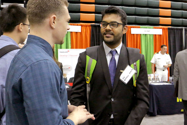 Animesh Johsi (graduate student in business analytics) chats with a recruiter at the UT Dallas Career Expo.