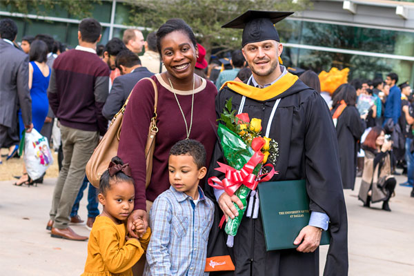 Master's in Information Technology Management graduate on commencement day, with this spouse and children