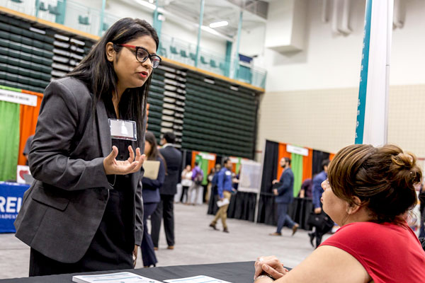 A graduate student in information technology and management chats with a recruiter about a full-time job as a business analyst.