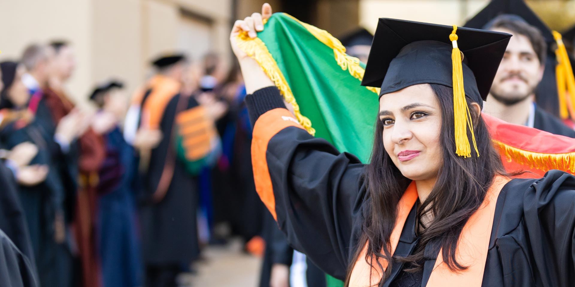 a student on UT Dallas commencement day who earned her bachelor's degree from the Naveen Jindal School of Management.